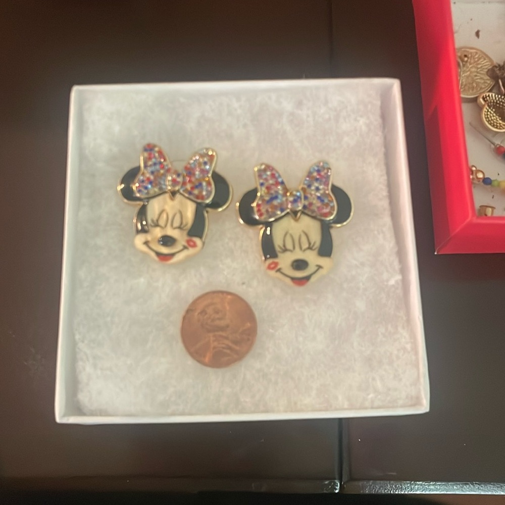 Earrings,penny size to see them,has multi  colored gems with ivory style face.